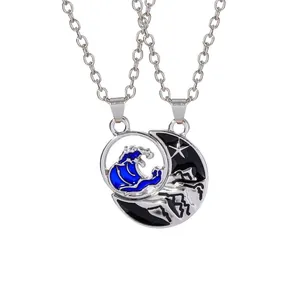 Matching sun and moon necklaces for couples with blue waves and mountain pendants