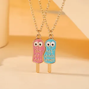 Detail of Best Friends ice cream necklaces with pink and blue enamel charms
