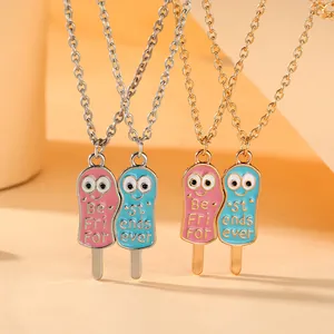 Close-up of pink and blue enamel ice cream best friends necklaces in gold and silver