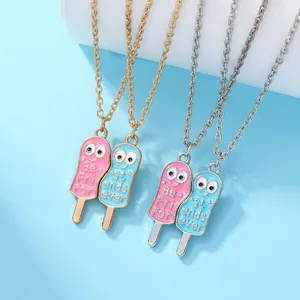 Detail of pink and blue enamel popsicle best friend necklaces with cartoon eyes