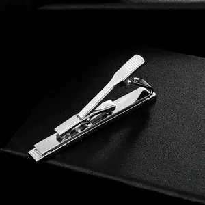 Polished silver business tie clip for men on black leather background for formal suits