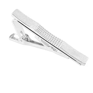 Silver tie clip for men with knurled diamond pattern texture on white background