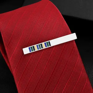 Elegant silver metal tie clip with colorful striped inlay on a classic red textured tie