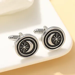 Detailed view of silver celestial cufflinks featuring a crescent moon and star design