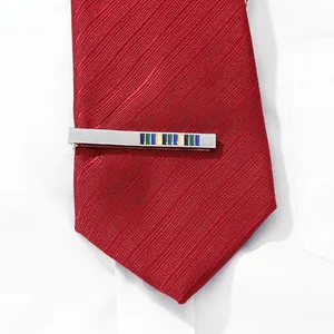 Detail of silver tie clip with colored enamel stripes on a red striped tie