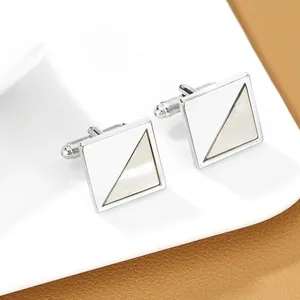 Detail view of silver square cufflinks with diagonal mother of pearl and enamel inlay