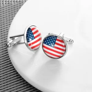 Detail of silver-tone cufflinks featuring American flag design under a crystal glass dome