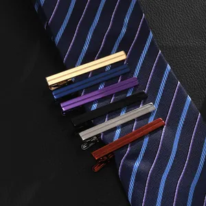 Set of six colorful business tie clips with stripe design on navy blue necktie