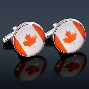 Macro shot of silver cufflinks featuring the Canadian flag on a reflective surface