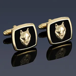 Detailed view of square gold-toned wolf head cufflinks with black enamel inlay