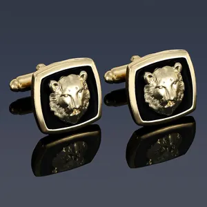 Detailed view of square gold-plated cufflinks featuring a 3D lion head on black enamel base