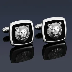 Detail of silver square cufflinks with black enamel and a 3D leopard head emblem