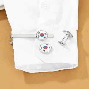 Detail view of silver cufflinks and tie clip set with South Korea flag on shirt cuff