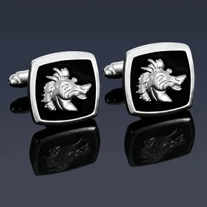 Detail view of silver square cufflinks featuring a 3D dragon head relief on black inlay