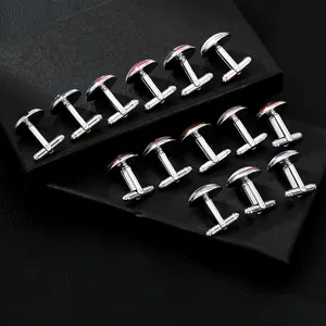 Polished silver cufflinks featuring world flags on a black leather jewelry display box