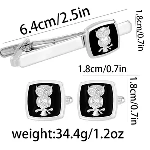 Men's silver cufflinks and tie clip set with owl patterns on a black background
