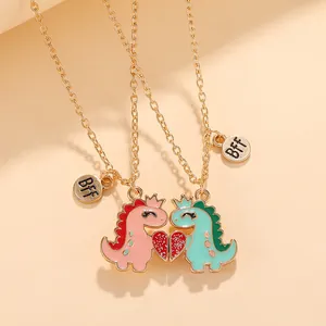 Detail of magnetic dinosaur friendship necklaces with BFF tags and heart pendant