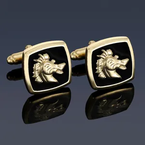 Detailed macro view of business cufflinks with golden dragon emblem on black enamel