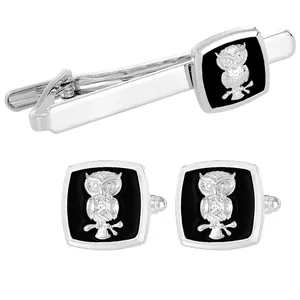 Men's silver owl cufflinks and tie clip set with black enamel inlay on white background