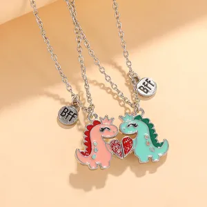 Close-up of magnetic dinosaur heart pendants with BFF tags for best friends necklace