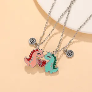 Detail of magnetic dinosaur friendship necklaces with heart pendants and BFF tags