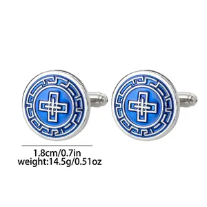 Detailed macro view of silver round cufflinks with blue enamel patterns and cross design