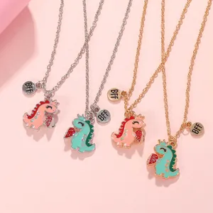 Detailed view of four colorful dinosaur BFF necklaces with magnetic crown heart pendants