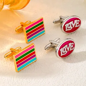 Macro shot of stylish rainbow striped and magenta LOVE engraved metal cufflinks for men
