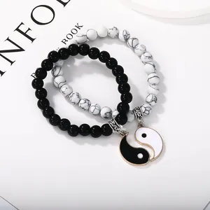 Detail of Yin Yang couples bracelets with black obsidian and white marble beads