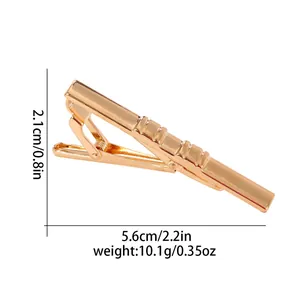 Polished gold metal tie clip for men featuring diagonal textured grip and crocodile clamp