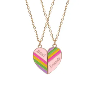 Detail of rose gold best friends heart necklace with colorful enamel puzzle design