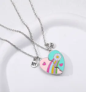 Macro detail of silver BFF friendship necklaces with colorful rainbow and daisy enamel pendants