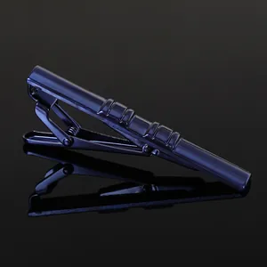 Macro shot of navy blue metallic tie clip with ribbed texture and mirror finish