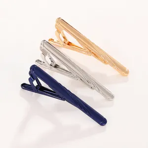 Close-up of gold, silver, and blue striped metal tie clips for business shirts