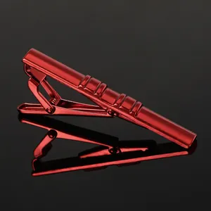 Detail shot of a bright red metal tie clip with stylish diagonal textured stripes