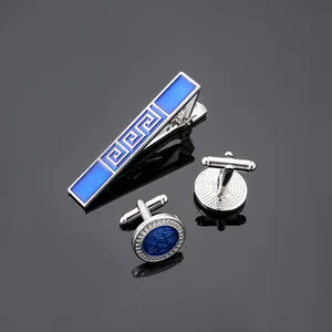 Macro detail of men's business tie clip and cufflinks set with blue Greek pattern