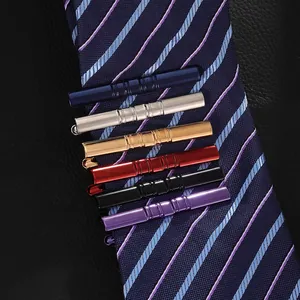 Set of six colorful polished metal necktie clips with engraved stripes for men