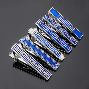 Macro shot of silver tie clip set with blue enamel and Greek key pattern