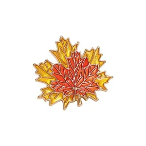 Elegant maple leaf brooch featuring vibrant orange-yellow gradients and gold-tone edges