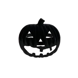 Detalle de un servilletero de calabaza negra brillante con diseño de Jack-o'-lantern