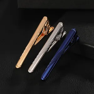 Detail of metallic tie clips in gold, silver and blue with fine diagonal stripes