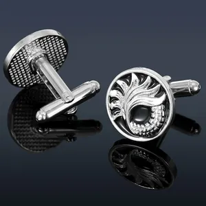Elegant silver cufflinks with feather relief and black enamel inlay on reflective background