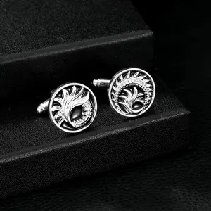 Detail showing round silver cufflinks with black oval stone and feather carvings