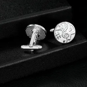 Polished silver musical symbol cufflinks with treble clef on a black leather gift box