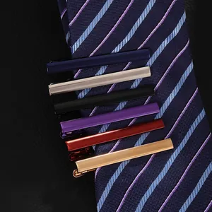 Set of 6 colorful business tie clips for men shown on a textured navy striped silk tie