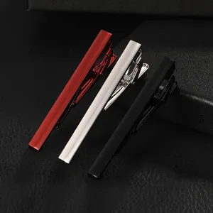 Macro detail of three elegant striped tie clips in red, silver and black metal colors