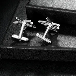 Men's star-shaped silver metal cufflinks with textured surface on a black gift box