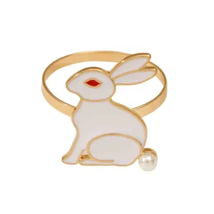 Elegant white enamel bunny napkin ring with golden edges and a pearl tail accent