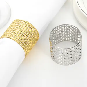 Close-up of gold and silver hollow woven mesh napkin rings for elegant table decor