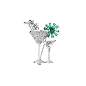 Detail of cocktail glass brooch with micro-pave crystals and emerald green flower gems